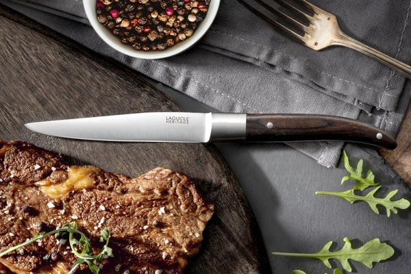 laguiole heritage steak knife with pakkawood handle. pakkawood is a dark wood